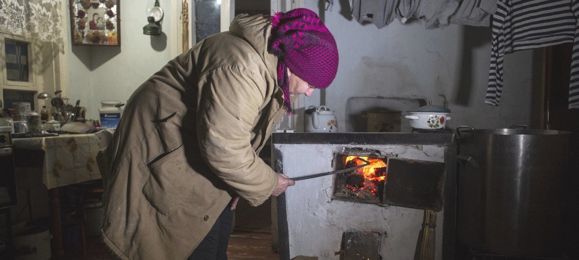Una mujer en el este de Ucrania enciende un fuego